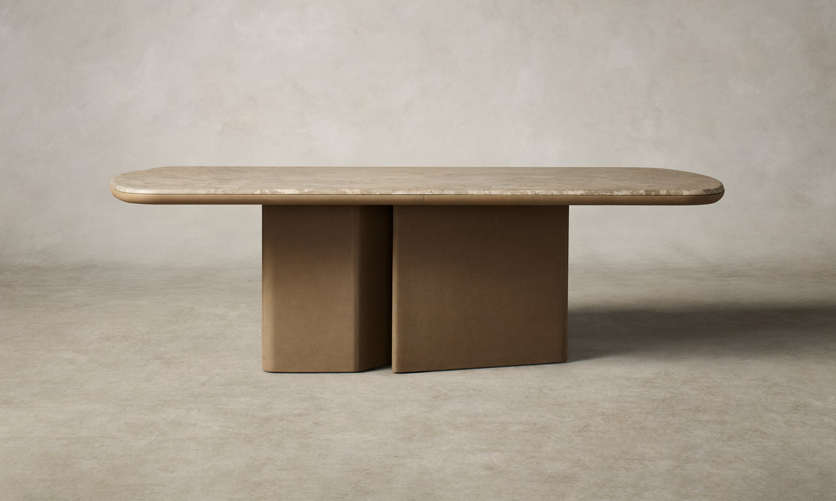The Cota Dining Table in camouflage stone with a Venetian leather fossil base.