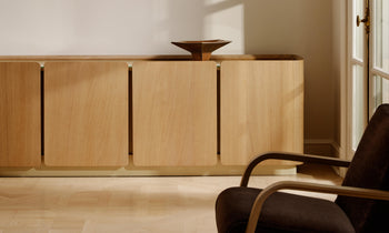 sabine oak wood sideboard with 4 doors and a glass top in a modern french living room