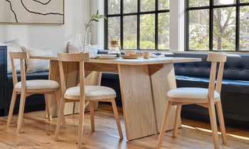 allen dining chair in light brown ash wood and white leather seat in a modern dining room