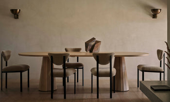 bank oval wood dining table in natural oak in a modern dining room