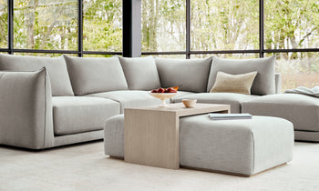 bowery ottoman with wood tray in white linen in a modern bedroom setting