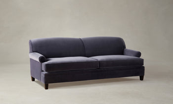 carmine sofa in purple velvet with pleated arms and tapered wooden legs - angle view