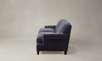 carmine sofa in purple velvet with pleated arms and tapered wooden legs - side view