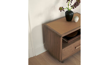 clinton large brown ash wood nightstand with one drawer and a leather inlay in a bedroom setting