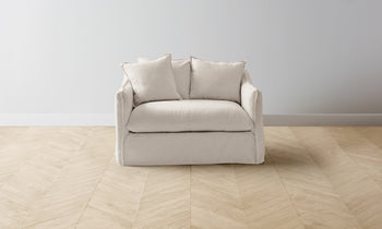 dune chair and half in white linen with cushions - front view