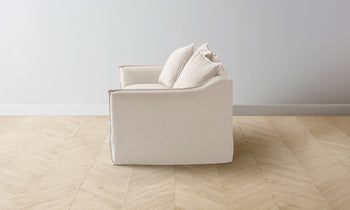 dune chair and half in white linen with cushions - side view