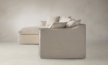 dune sectional sofa with chaise in beige linen with throw pillows - side view