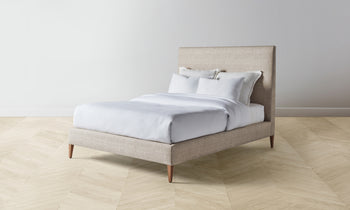 essex bed with upholstered headboard and frame in beige with wooden legs