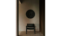 hyde black oak chair in black leather in a modern living room