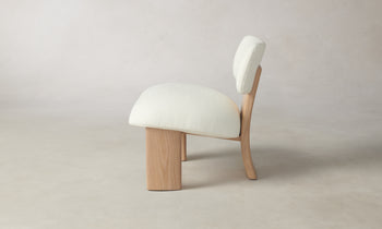 kenmare accent chair in white linen with ash wood frame and three legs - side view