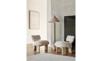 kenmare accent chair in white shearling with ash wood curved frame and three legs in a modern living room