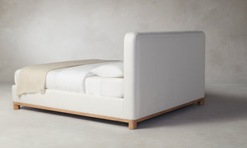 kent bed with upholstered frame and headboard in white linen with wood trim - back view