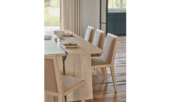 madison dining chair in brown ash wood  with beige mohair fabric in a modern dining room