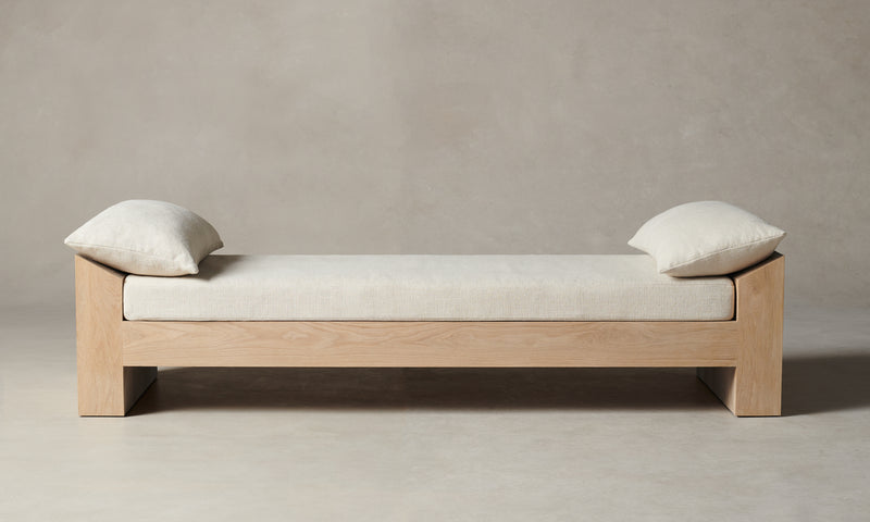 montauk wooden daybed in white linen with pillows 