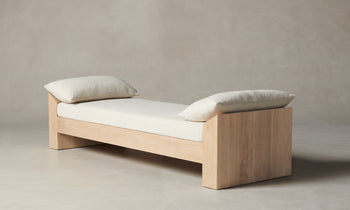 montauk wooden daybed in white linen with throw pillows - side view