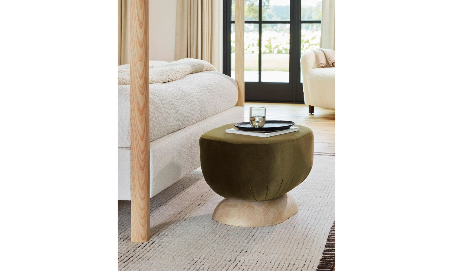 mott stool with wood base and olive mohair fabric in a modern bedroom