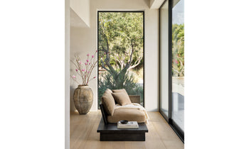 muir sofa with built in table in brown velvet fabric and black wooden frame in a modern sunroom