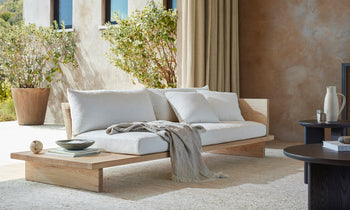 muir sofa with built in table in white chenille fabric and wooden frame in a modern living room