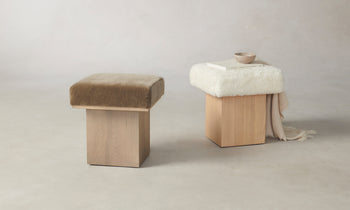 two mulberry ottomans with ash wood base, mink mohair fabric and a shearling white fabric