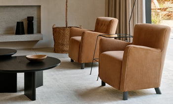 perry accent chair in brown leather with wooden legs - in a designed room