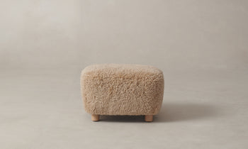 perry brown shearling ottoman with maple wood legs