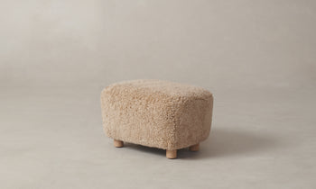 perry brown shearling ottoman with maple wood legs - side view