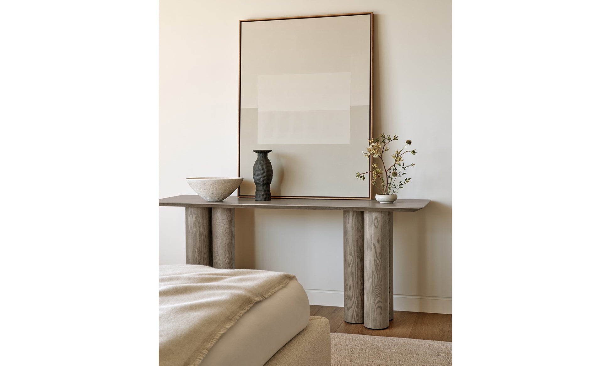 reade console table in grey ash wood in a modern bedroom