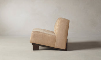 remsen accent chair upholstered in brown pony hair with wooden legs and geometric design - side view