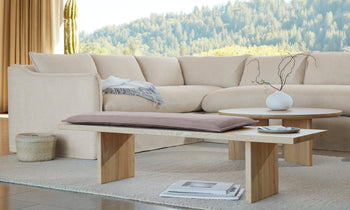 reyes wood bench with taupe nubuck leather cushion in a modern living room