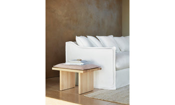 reyes wooden stool with gray leather cushion in a modern room decor