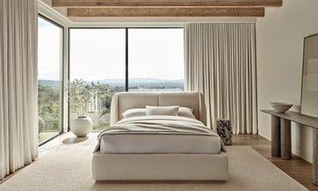 smith bed with upholstered frame and headboard in white boucle in a modern bedroom