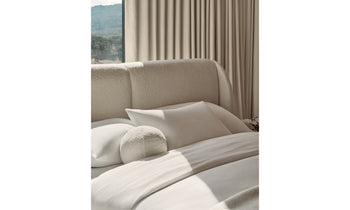 smith bed with upholstered headboard in white boucle in a bedroom setting