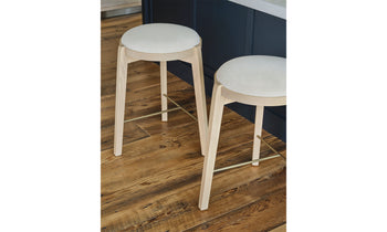 stanton wood counter stools in white ash wood with white leather seat in a modern room