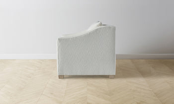 sullivan accent chair in white boucle with wooden legs - side view