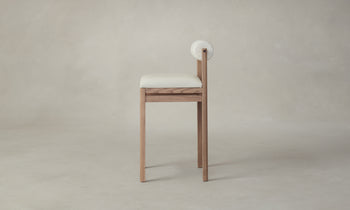 thayer wood barstool in oak with white leather seat and bolster back, side view