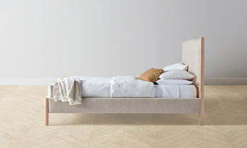 thompson upholstered bed in beige linen with ash wood legs - side view