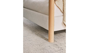 thompson canopy bed upholstered in white boucle with ash wooden legs