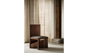 venice chair in brown oak with grey linen seat and geometric design in a modern living room